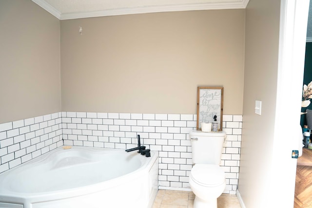 11005 Elm Ave, Howard City, MI 49329 - bathroom with tile walls, a garden tub, toilet, crown molding, and wainscoting
