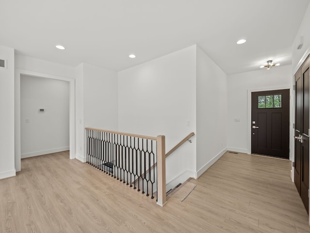 foyer entrance featuring light wood finished floors, recessed lighting, and baseboards
