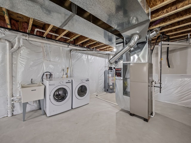 unfinished basement featuring water heater, independent washer and dryer, and heating unit