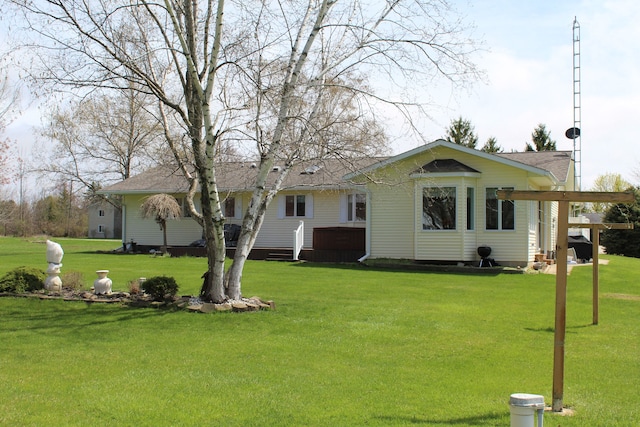 275 Madison St, Port Austin, MI 48467 - rear view of property featuring a yard and roof with shingles