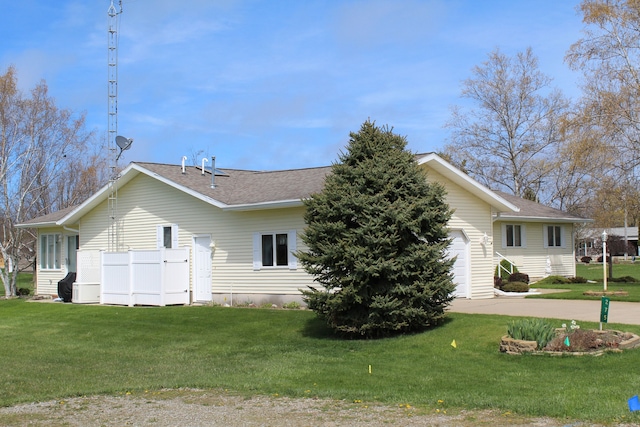 275 Madison St, Port Austin, MI 48467 - view of property exterior featuring a lawn and a shingled roof