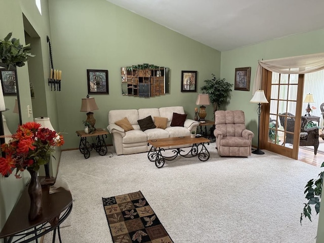275 Madison St, Port Austin, MI 48467 - carpeted living room featuring vaulted ceiling and baseboards