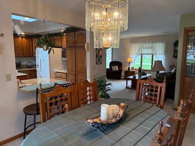 275 Madison St, Port Austin, MI 48467 - dining room featuring an inviting chandelier, carpet floors, and baseboards