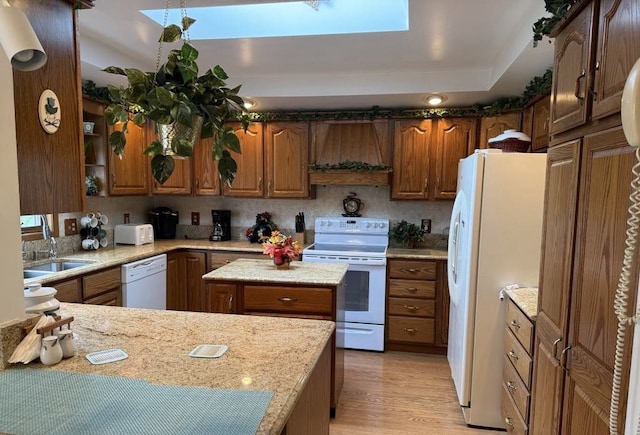 275 Madison St, Port Austin, MI 48467 - kitchen featuring light wood-type flooring, brown cabinets, a sink, and white appliances