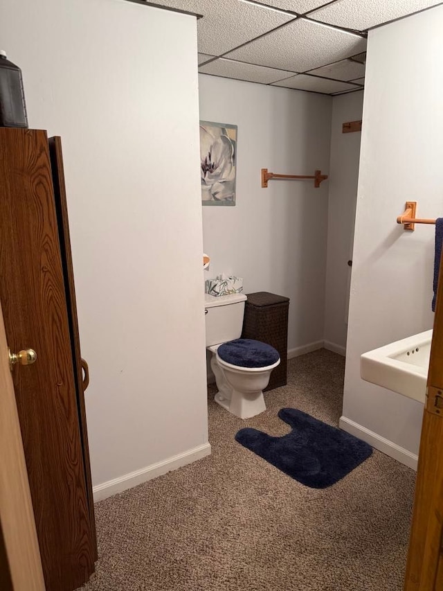 275 Madison St, Port Austin, MI 48467 - bathroom featuring toilet, baseboards, and a paneled ceiling