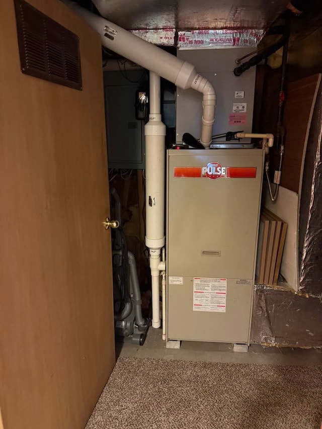 275 Madison St, Port Austin, MI 48467 - utility room with heating unit and visible vents
