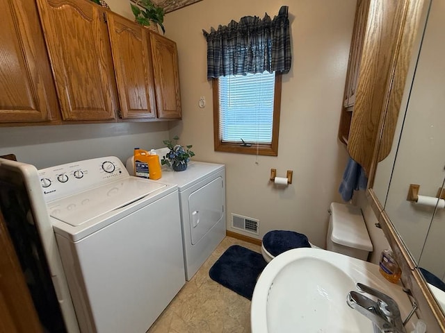 275 Madison St, Port Austin, MI 48467 - laundry room featuring baseboards, washer and dryer, visible vents, and a sink