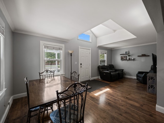 dining space featuring a wealth of natural light, ornamental molding, vaulted ceiling with skylight, and wood finished floors