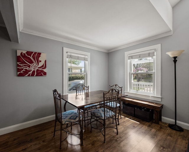 dining room featuring crown molding, wood finished floors, and baseboards