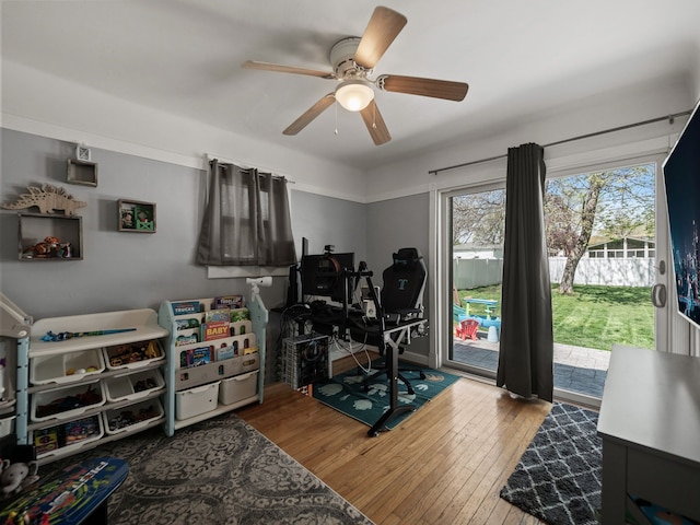 game room featuring wood-type flooring and ceiling fan