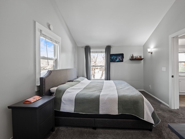 carpeted bedroom featuring lofted ceiling, baseboards, and multiple windows