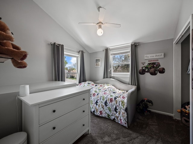 bedroom featuring vaulted ceiling, a ceiling fan, and dark colored carpet