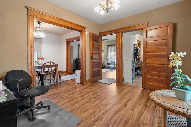 office featuring light wood-style floors and an inviting chandelier