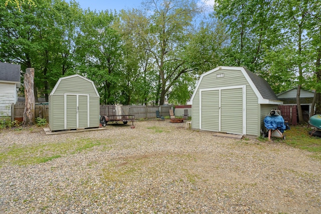 view of yard featuring an outbuilding, a fenced backyard, and a shed