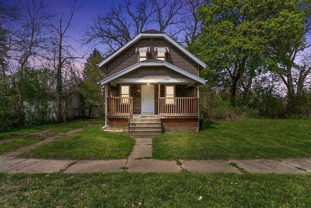 5011 Baldwin Blvd, Flint, MI 48505 - bungalow-style house with covered porch and a front lawn