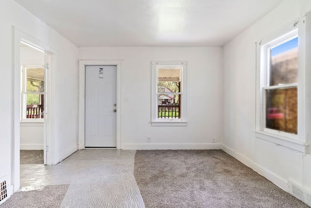 5011 Baldwin Blvd, Flint, MI 48505 - foyer entrance featuring light carpet, visible vents, and a healthy amount of sunlight