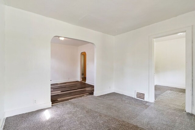 5011 Baldwin Blvd, Flint, MI 48505 - carpeted spare room with arched walkways, baseboards, and visible vents