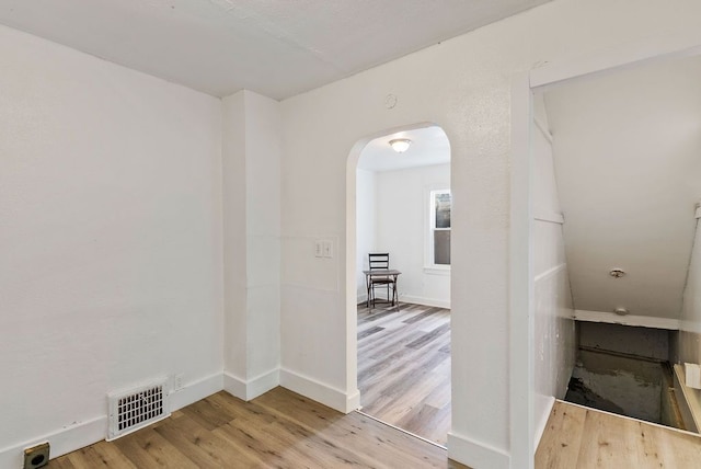 5011 Baldwin Blvd, Flint, MI 48505 - interior space featuring visible vents, wood finished floors, baseboards, and arched walkways