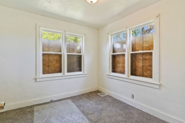 5011 Baldwin Blvd, Flint, MI 48505 - spare room with dark colored carpet and baseboards