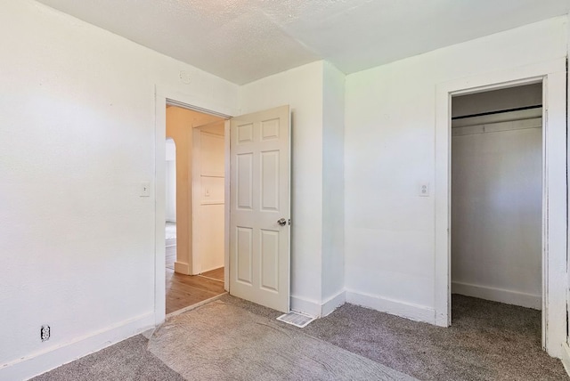 5011 Baldwin Blvd, Flint, MI 48505 - unfurnished bedroom with baseboards, carpet flooring, and a closet