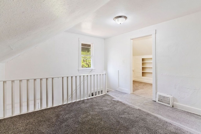 5011 Baldwin Blvd, Flint, MI 48505 - bonus room with a textured ceiling, carpet, baseboards, and visible vents