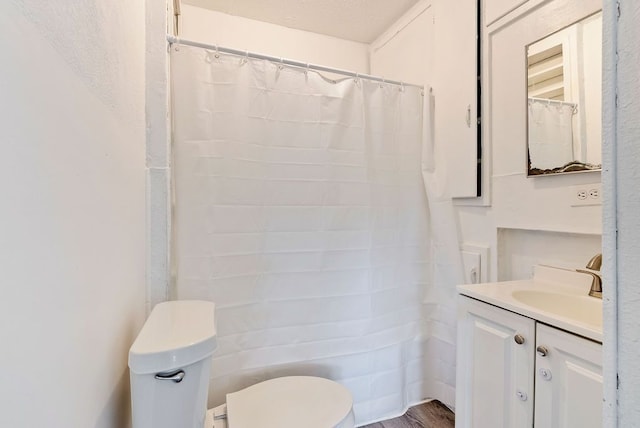 5011 Baldwin Blvd, Flint, MI 48505 - bathroom featuring toilet, wood finished floors, and vanity