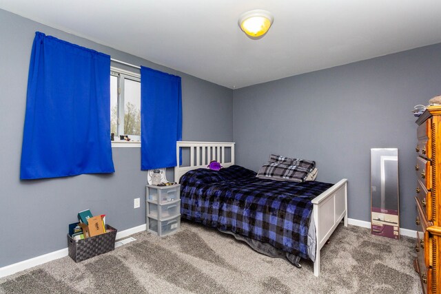 bedroom featuring carpet floors and baseboards