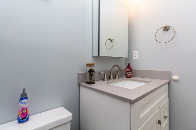 bathroom featuring toilet and vanity