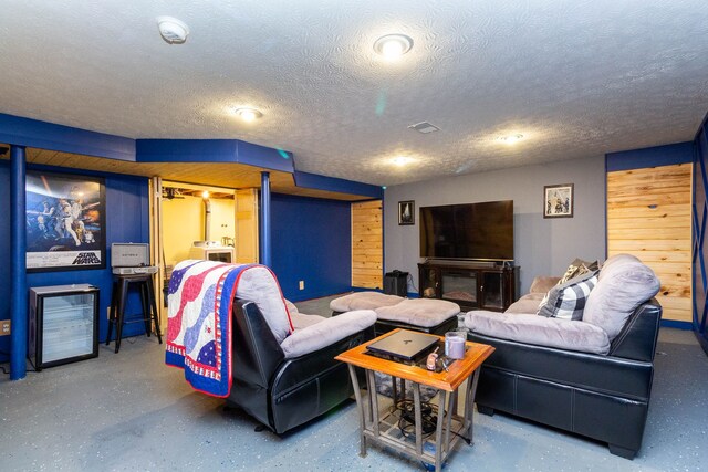 living area with a textured ceiling and visible vents
