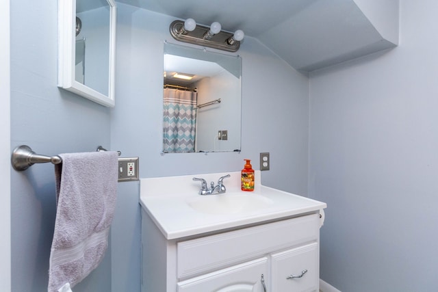 bathroom featuring vanity and vaulted ceiling