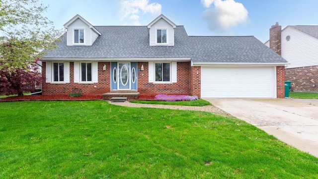 new england style home with driveway, brick siding, an attached garage, a front yard, and roof with shingles