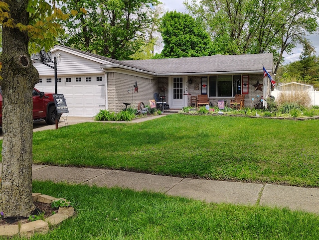 single story home with brick siding, an attached garage, a front yard, and a porch