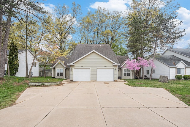 view of front facade featuring roof with shingles, concrete driveway, an attached garage, and a front yard