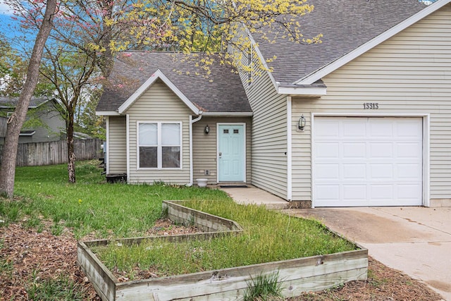 view of front of property with a shingled roof, driveway, fence, and a front lawn
