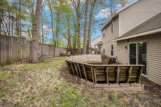 view of yard with a fenced backyard and cooling unit