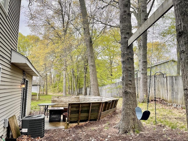 view of yard featuring cooling unit and fence