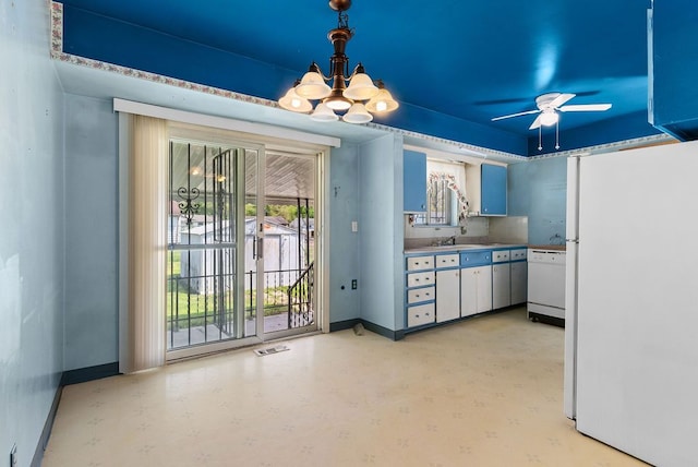kitchen with white appliances, a chandelier, baseboards, and ceiling fan