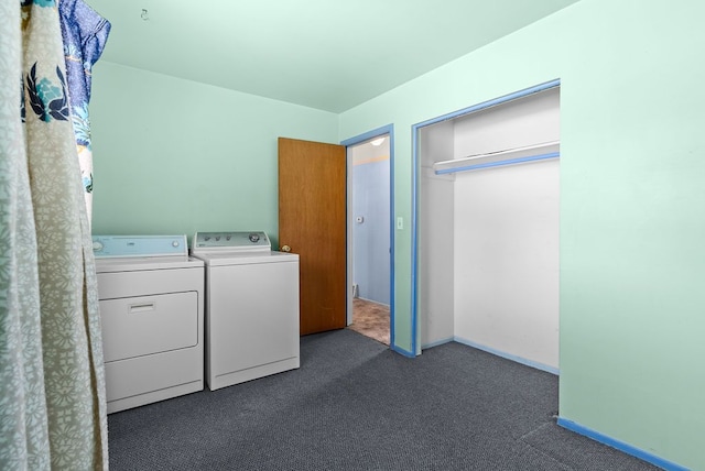 laundry room with washing machine and dryer, dark carpet, and baseboards