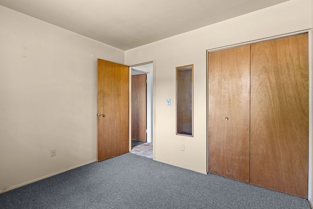 unfurnished bedroom featuring carpet flooring, a closet, and baseboards