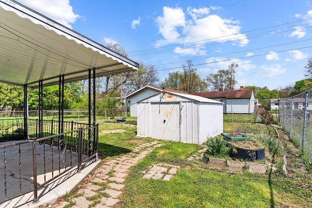 view of yard with a garden, a shed, and an outdoor structure