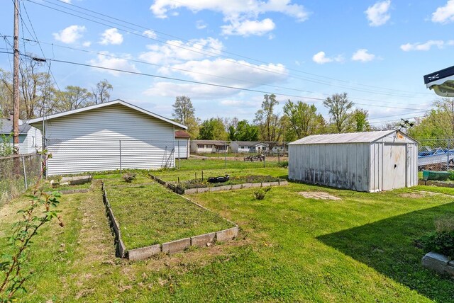 view of yard with a garden, an outdoor structure, and a storage unit