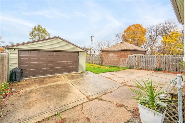detached garage with central AC unit and fence