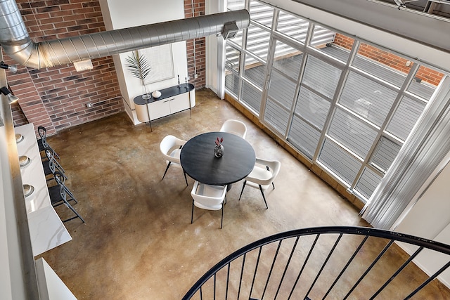 interior space with brick wall and concrete floors