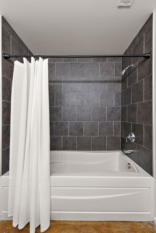 bathroom featuring shower / tub combo with curtain and visible vents