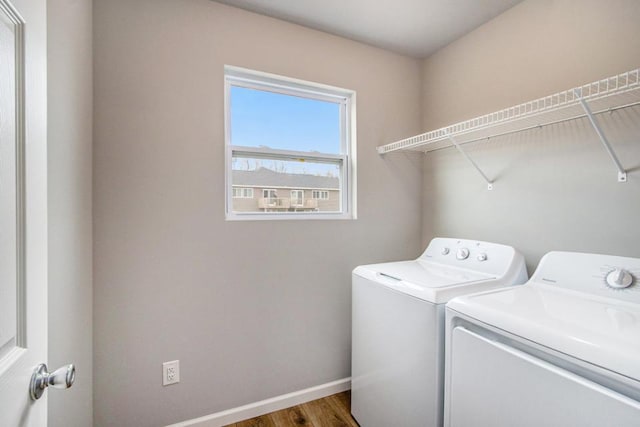 laundry room featuring laundry area, wood finished floors, baseboards, and washing machine and clothes dryer