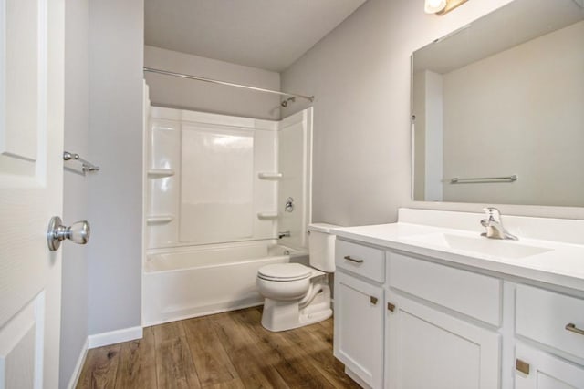 bathroom with toilet, shower / bathtub combination, wood finished floors, vanity, and baseboards