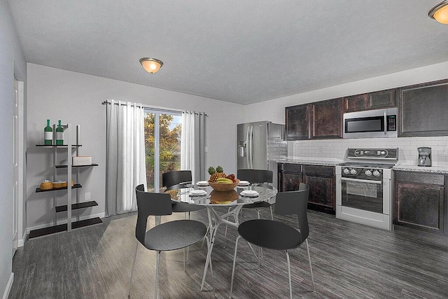 dining space featuring baseboards and dark wood-style flooring