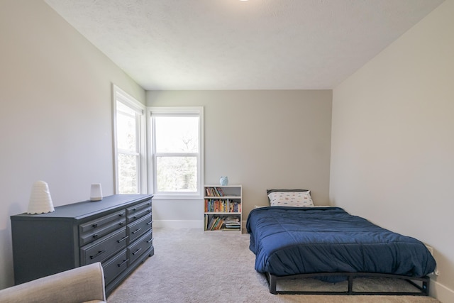 carpeted bedroom with baseboards