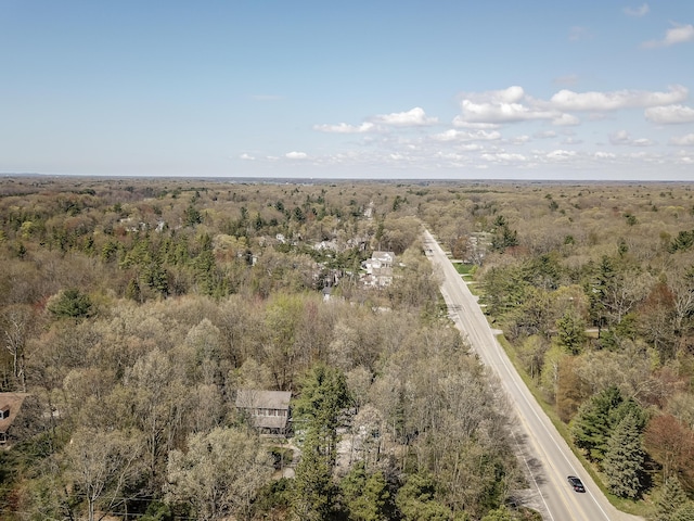 birds eye view of property with a forest view
