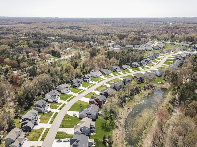 drone / aerial view featuring a forest view and a residential view